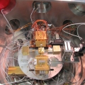 The complex system of sensors inside the vacuum chamber of the torsion pendulum test bench for testing the performance of the LISA Pathfinder GRS flight model: the cubic capacitive sensor with orange cables is the LISA Pathfinder Gravitational Reference Sensor.